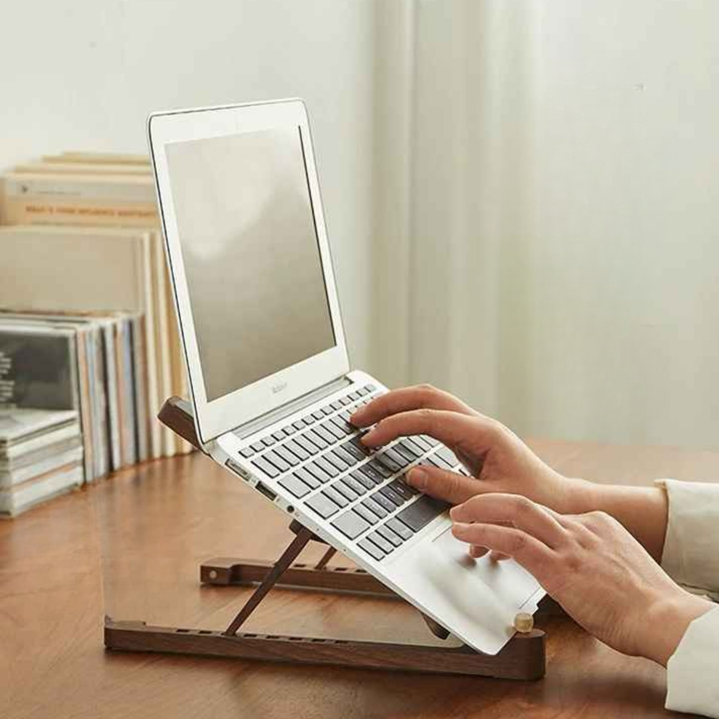 mains sur ordinateur sur support pc portable en bois 